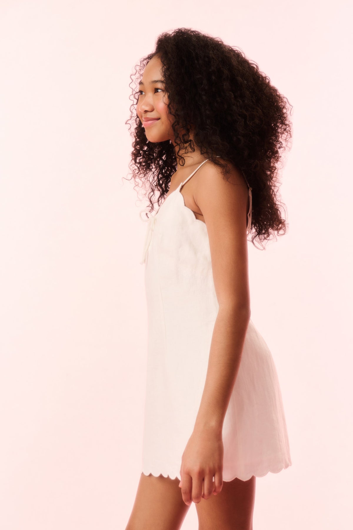 Girls off-white linen mini dress, sleeveless with scalloped hem