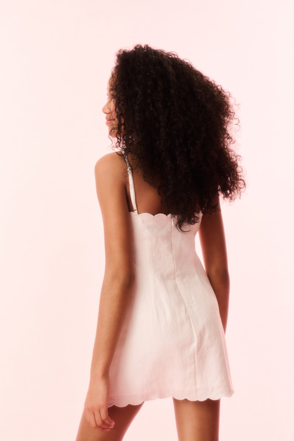Girls off-white linen mini dress with bow-tie neckline and scalloped hem