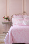 Pink floral duvet cover and sham set with ruffled pillows and heart accent