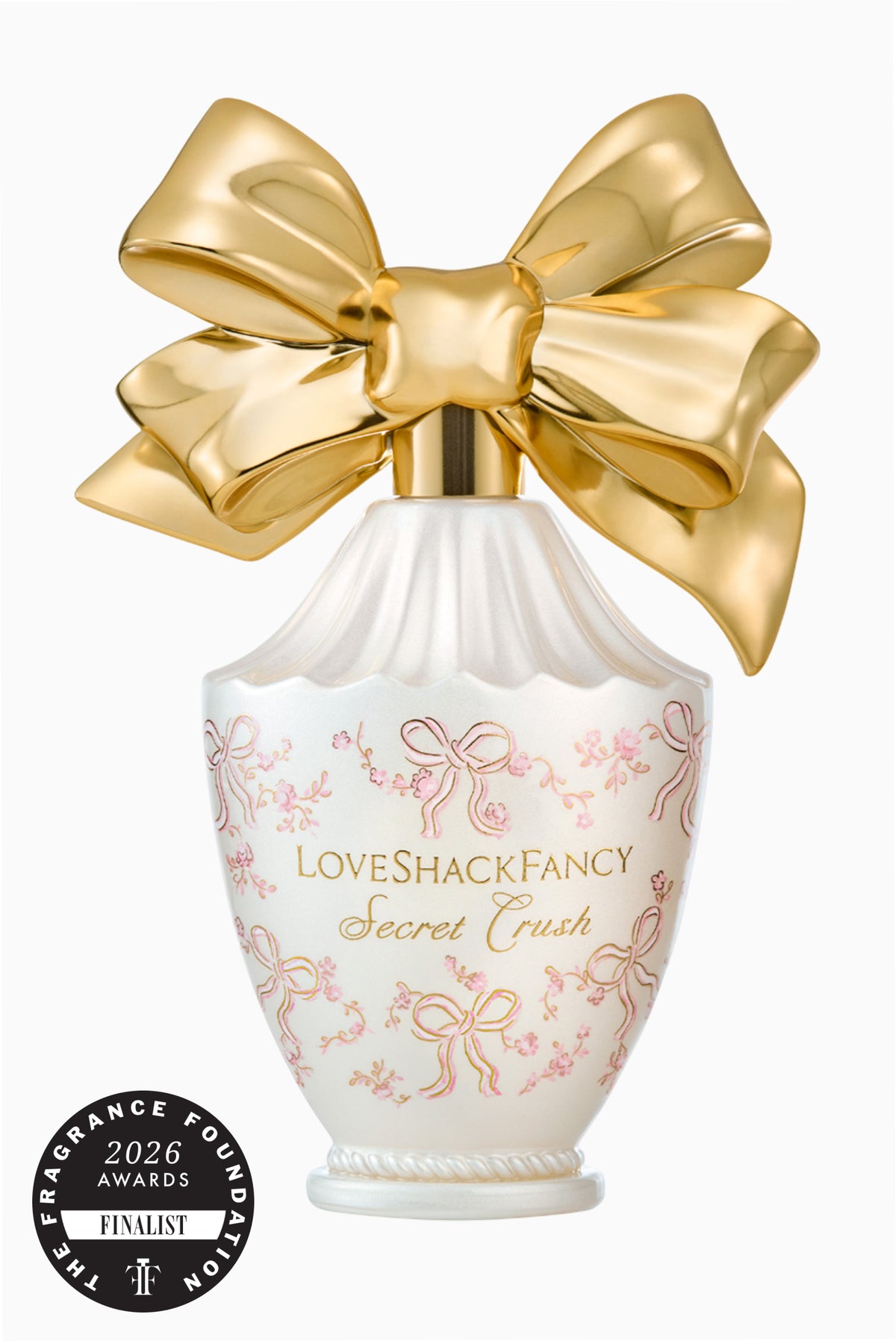 Eau de parfum bottle with gold bow, pink floral label, and award seal badge