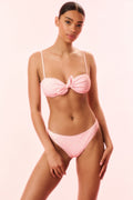 Shell pink polka-dot bikini set with knotted bandeau top and matching high-cut briefs