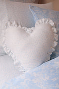 Heart-shaped ruffle pillow in light blue with small floral print and frilled edge