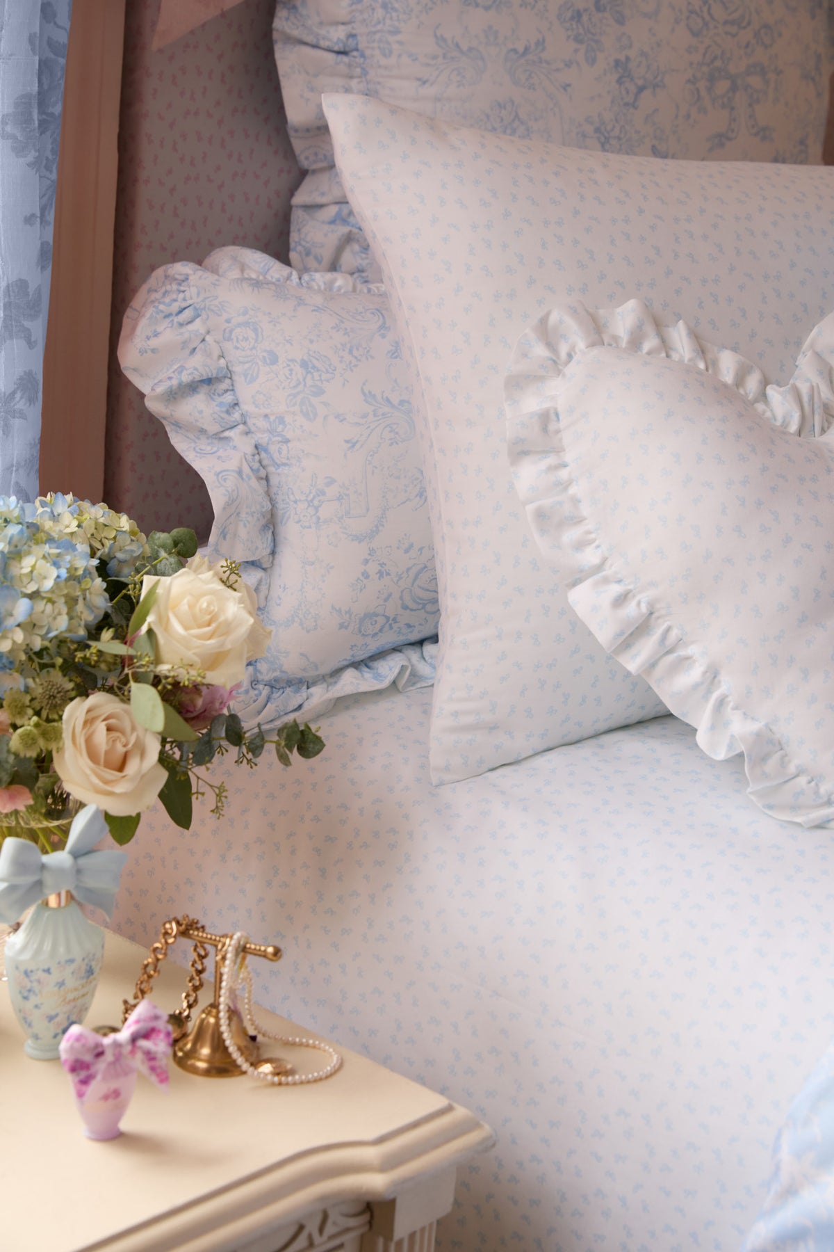 Pink printed cotton bedding set with pillows and ruffled detailing