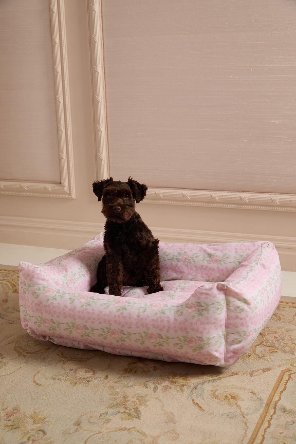Pink printed dog bed with cushioned bolstered sides