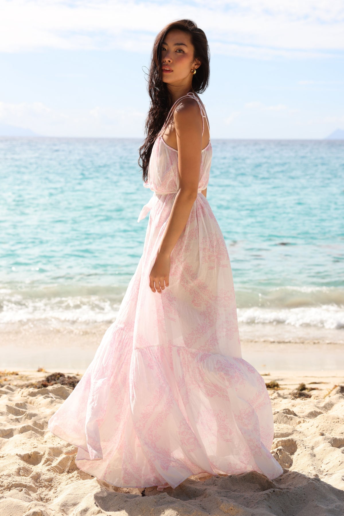 Toile print cover-up dress with thin straps, tie waist, and flowing tiered skirt in pale pink