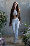 Tan suede fringe jacket worn with long fringe detail down the front.