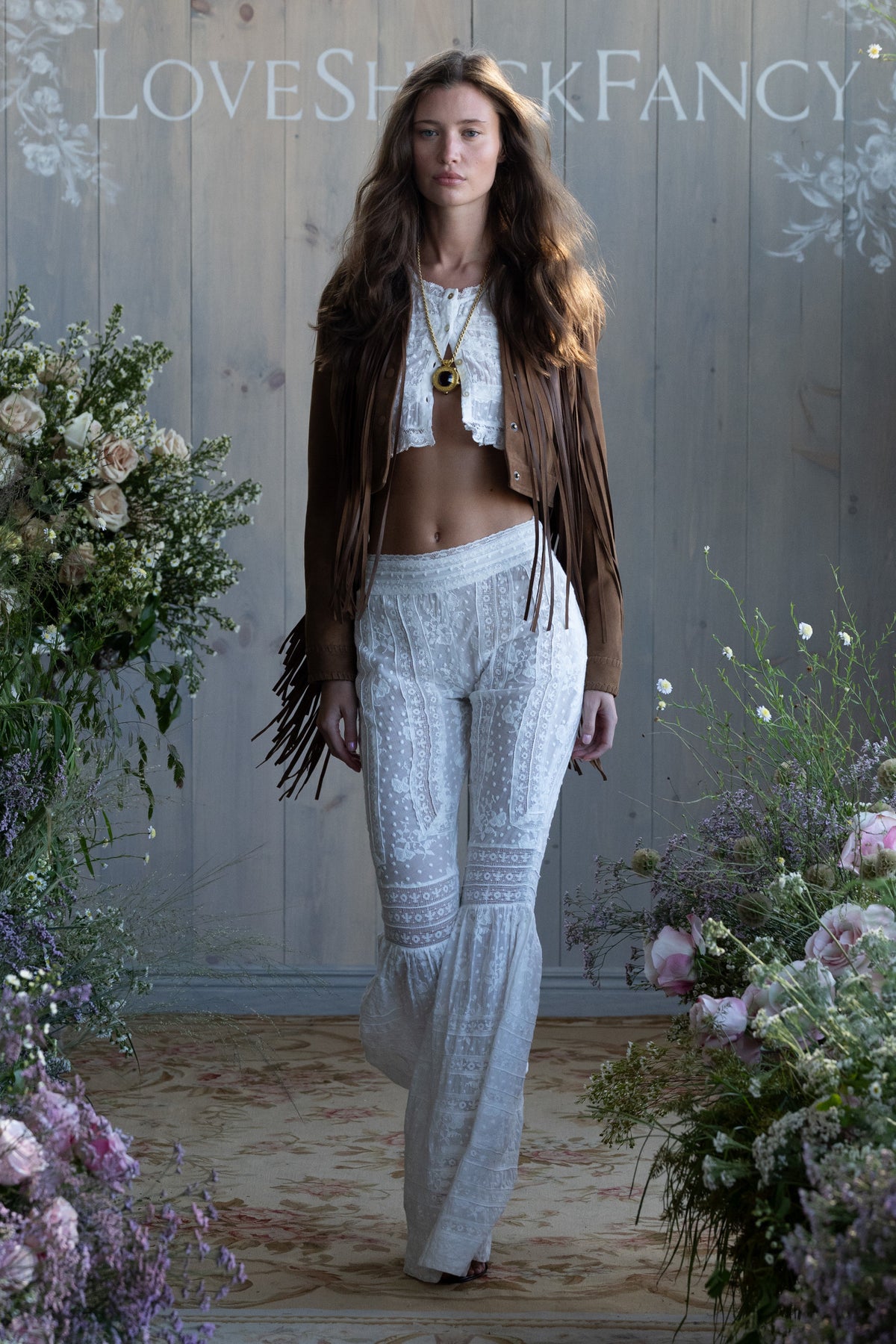 Tan suede fringe jacket worn with long fringe detail down the front.