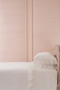 White ruffled pillowcase with lace edge and gathered seam detail on pillow