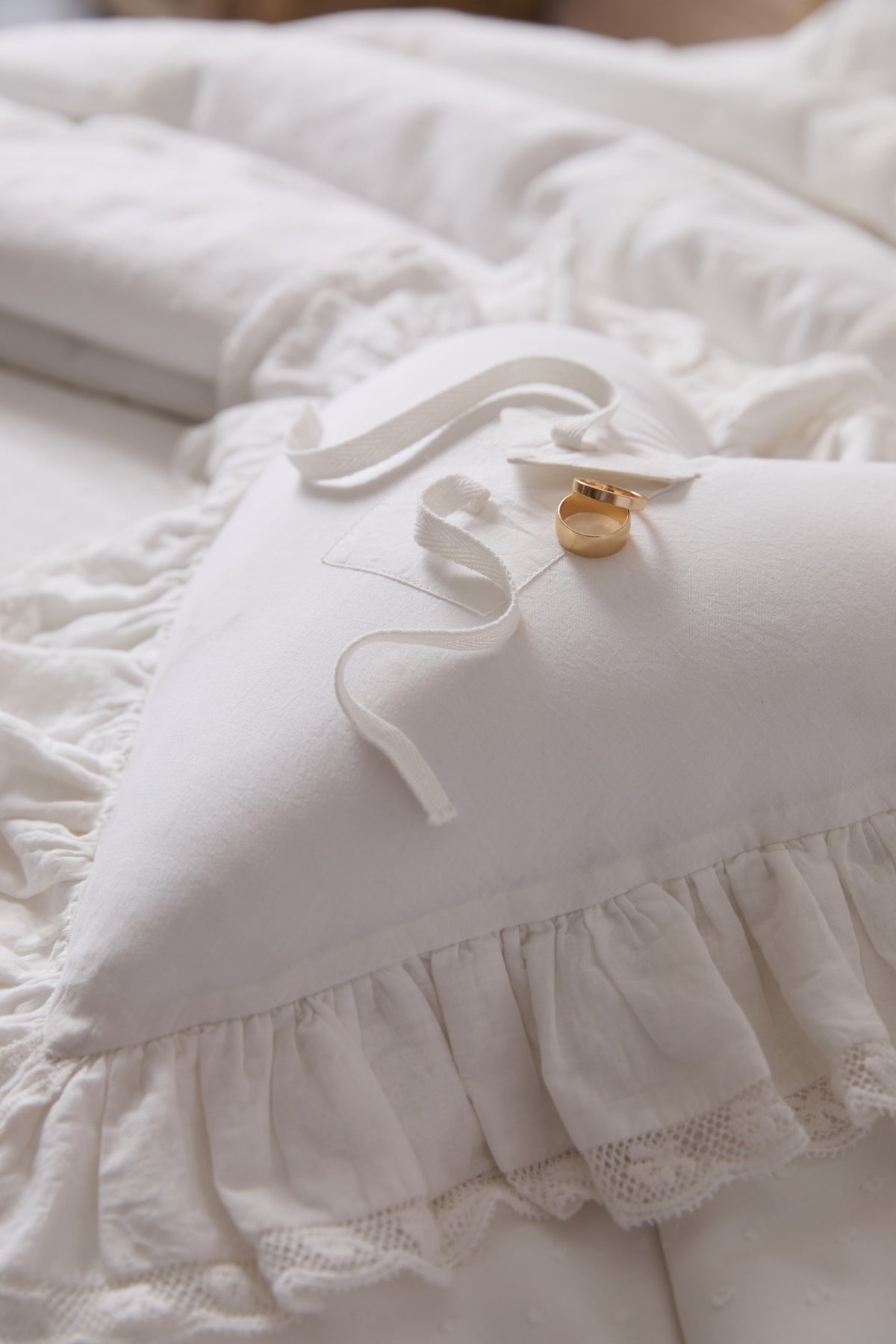 White heart-shaped mini accent pillow with scalloped lace ruffle trim