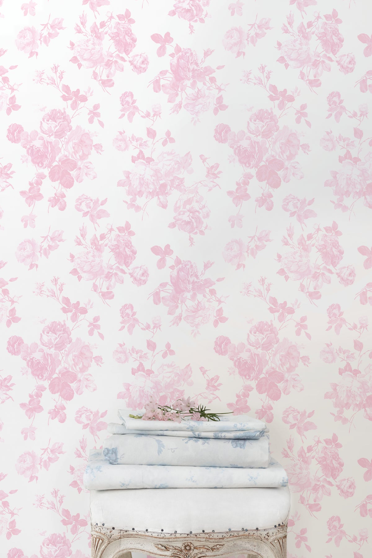 Pink floral rosette wallpaper pattern, light background with dense blossoms