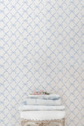 Light blue bow trellis pattern wallpaper on white background.