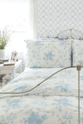 Powder blue bow trellis wallpaper with repeating chain-link ribbon knots.