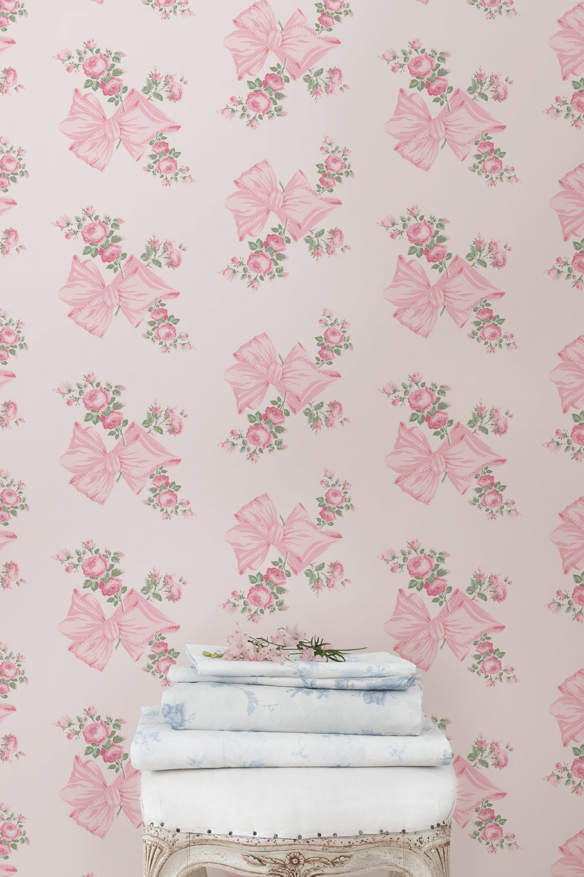 Pink and mint floral wallpaper pattern with roses and bow butterflies on a wall