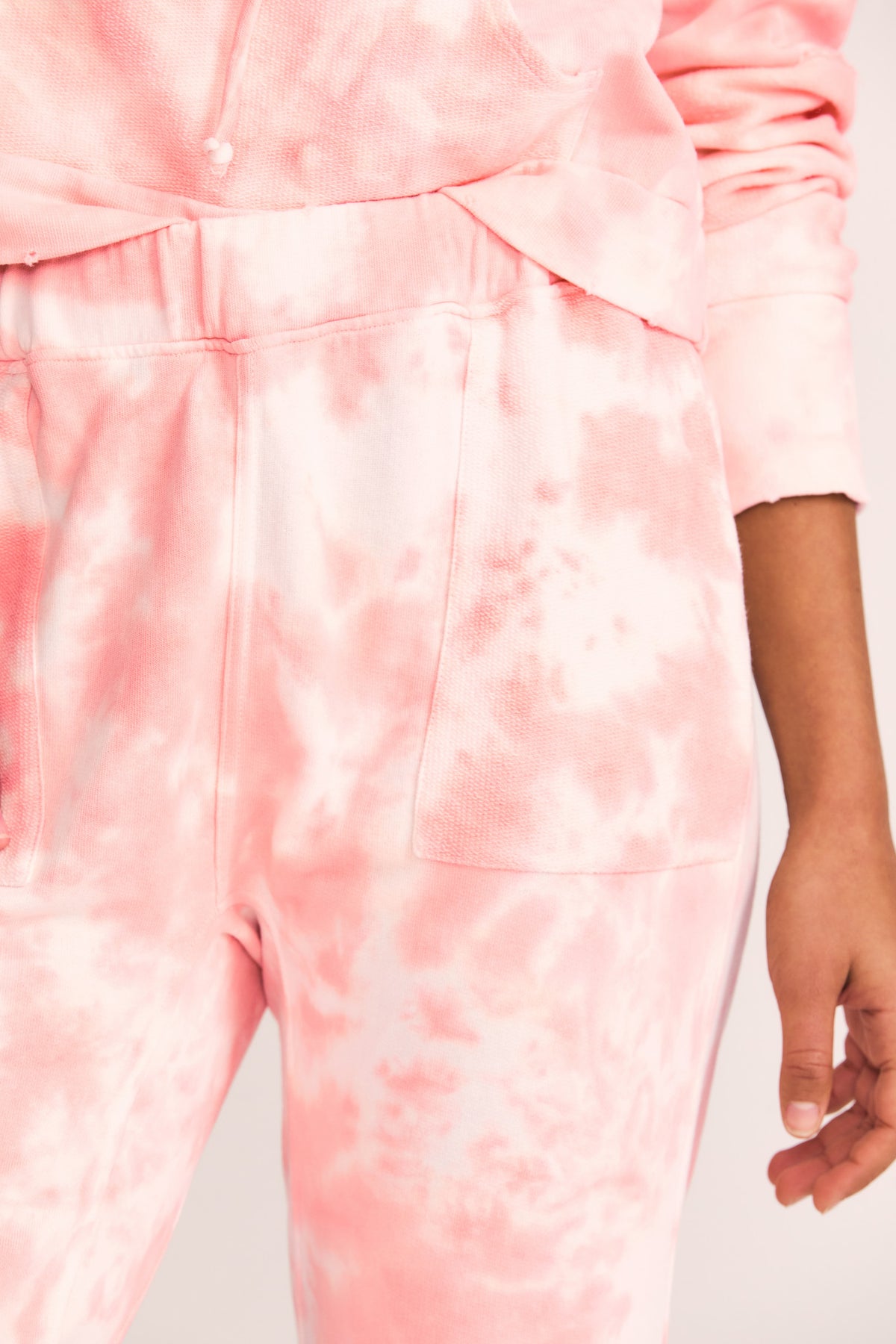 Blex jogger sweatpants close-up: front pocket and drawstring waist, light pink tie-dye