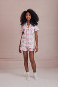 Women’s light pink polo pajama set with bow print, short sleeves and matching shorts
