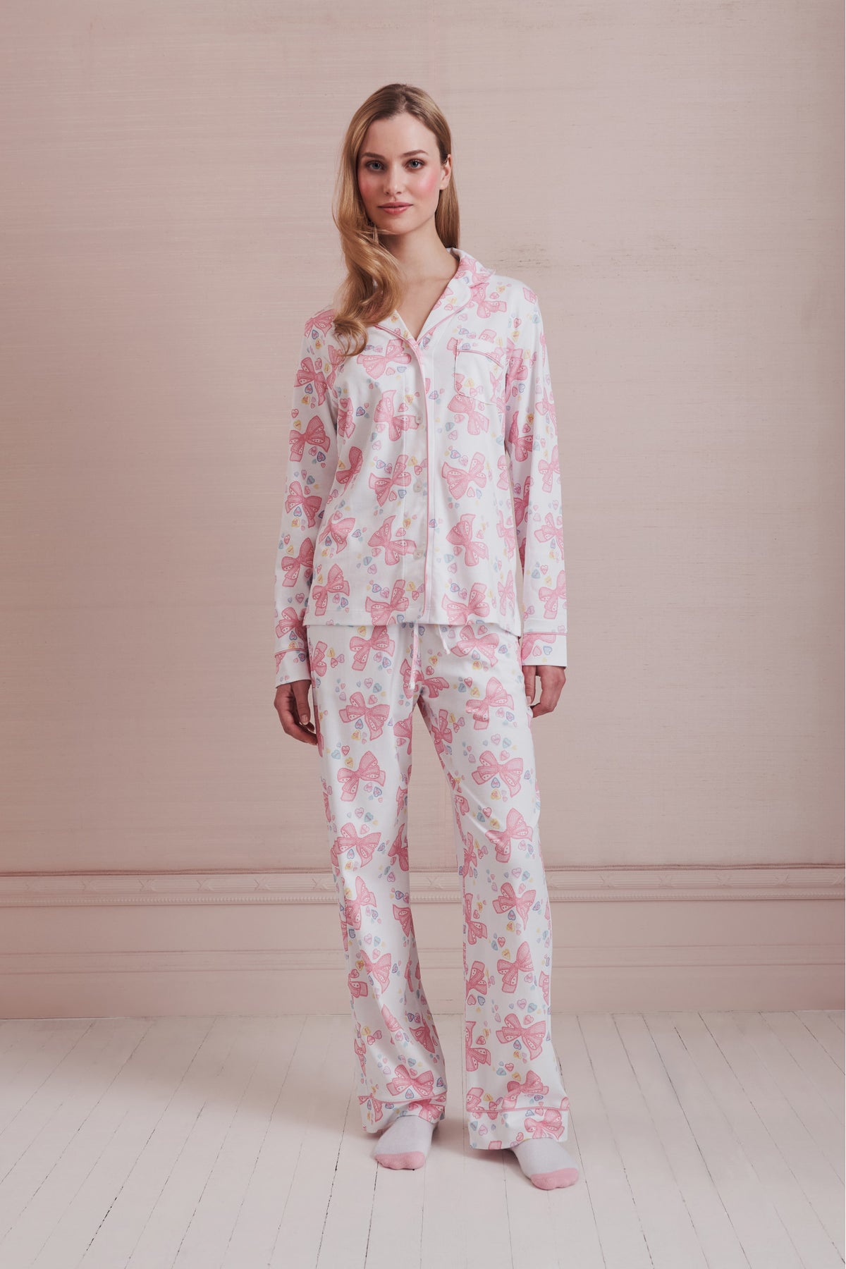 Women's long-sleeve pajama set in pink-and-white bow print, button-front top and pants