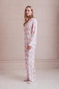 Women's long-sleeve pajama set in pink-and-white bow print, side view of top and pants