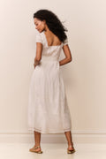 White midi dress with short puff sleeves, tiered gathered skirt, open back