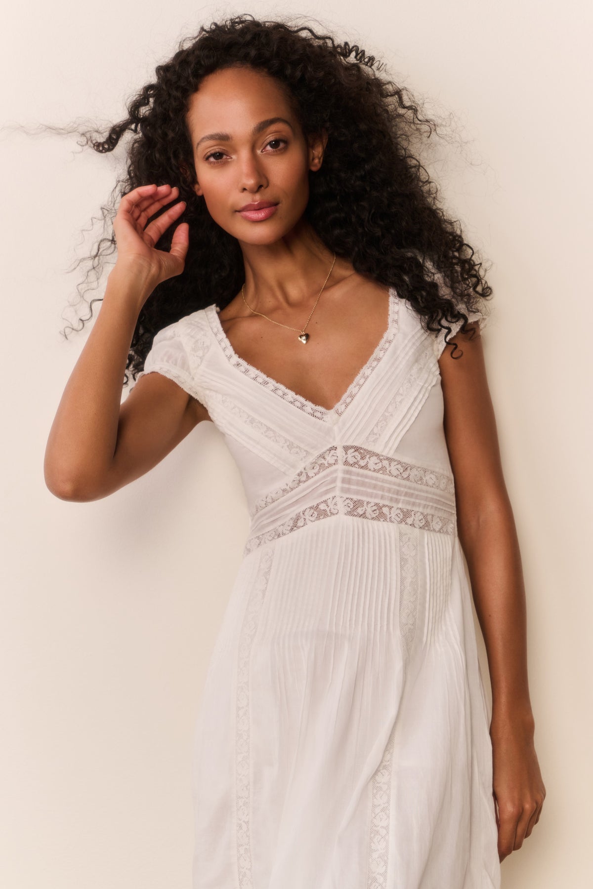 White midi dress with V-neck lace bodice, textured embroidery, short puff sleeves