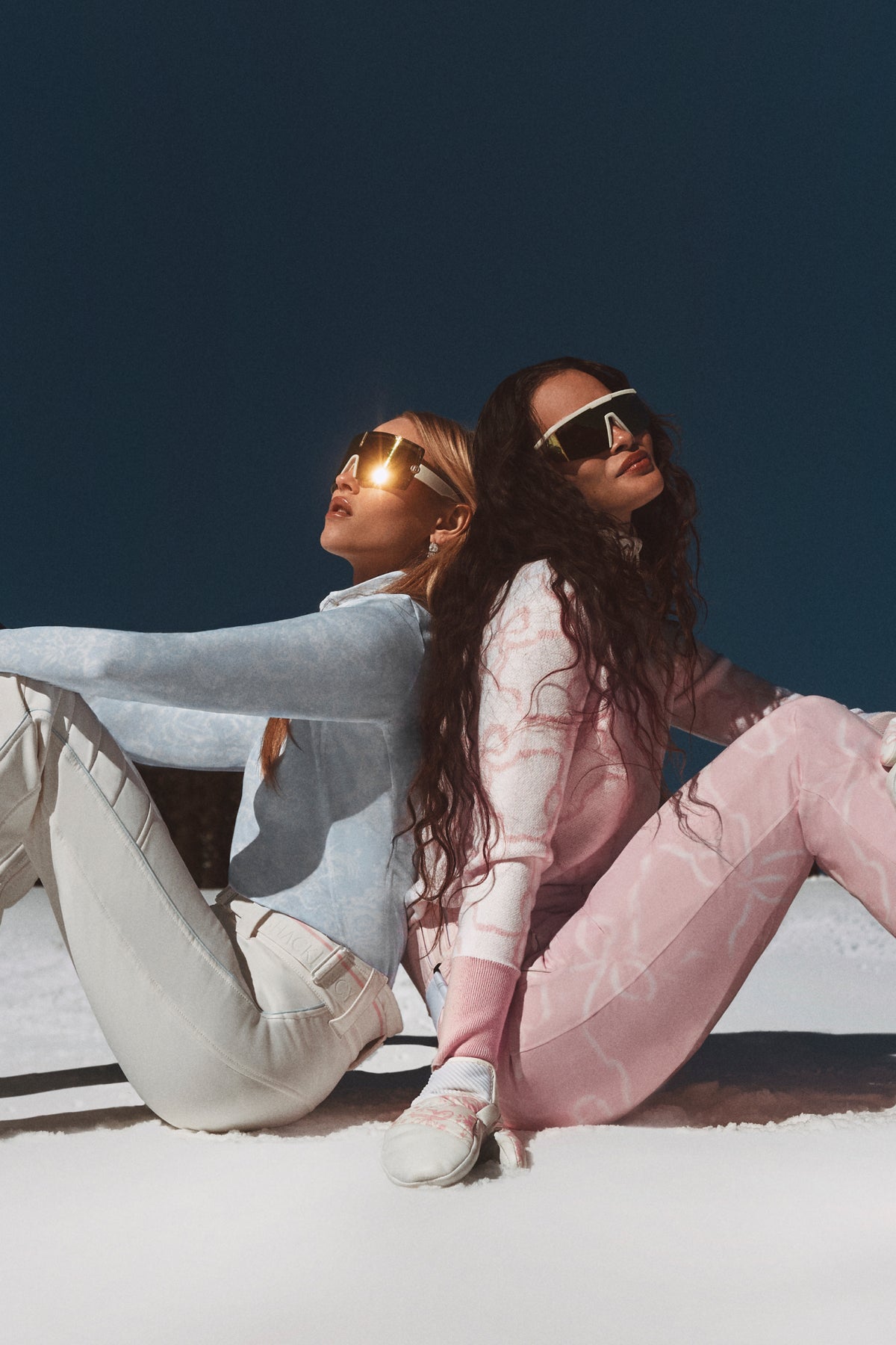 Light pink patterned ski pants shown in full length on a model