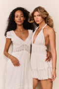 White midi dress with V-neck lace panel, gathered tiered skirt, short puff sleeves