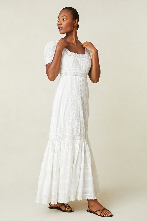 White Victorian maxi dress with textured bodice, square neck, puff sleeves, tiered hem