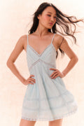 Upcycled cotton mini dress with V-neck lace trim and light blue tiered skirt