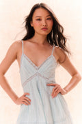Light blue upcycled cotton mini dress with thin straps and V-neck lace trim