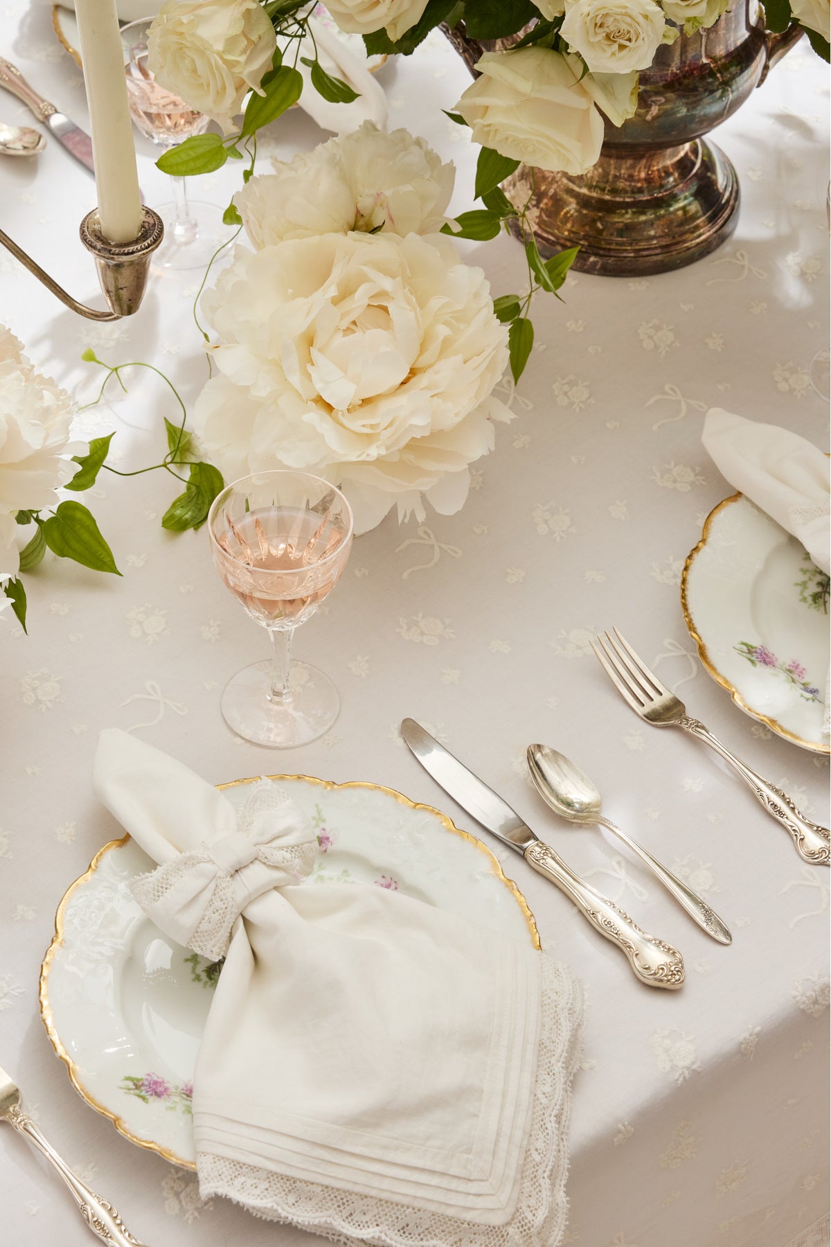 White embroidered napkin with ruffled edge and delicate stitched detail