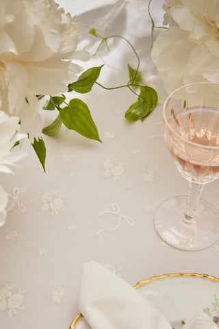 White table runner with subtle floral embroidery pattern