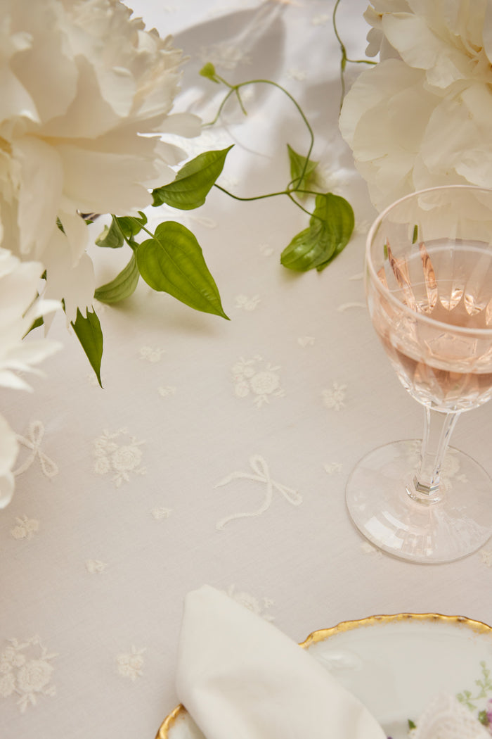 White table runner with subtle floral embroidery pattern