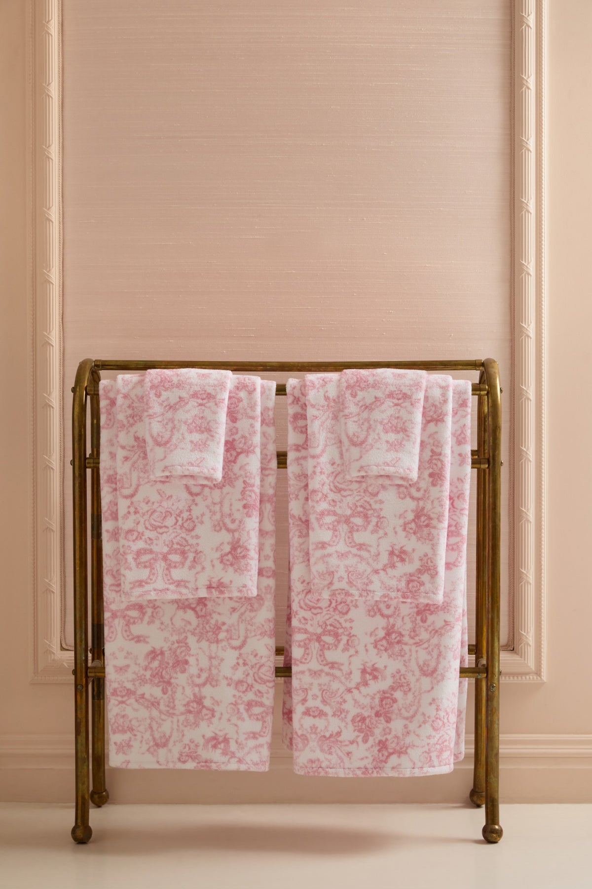 Pair of pink cotton hand towels with all-over floral print, folded