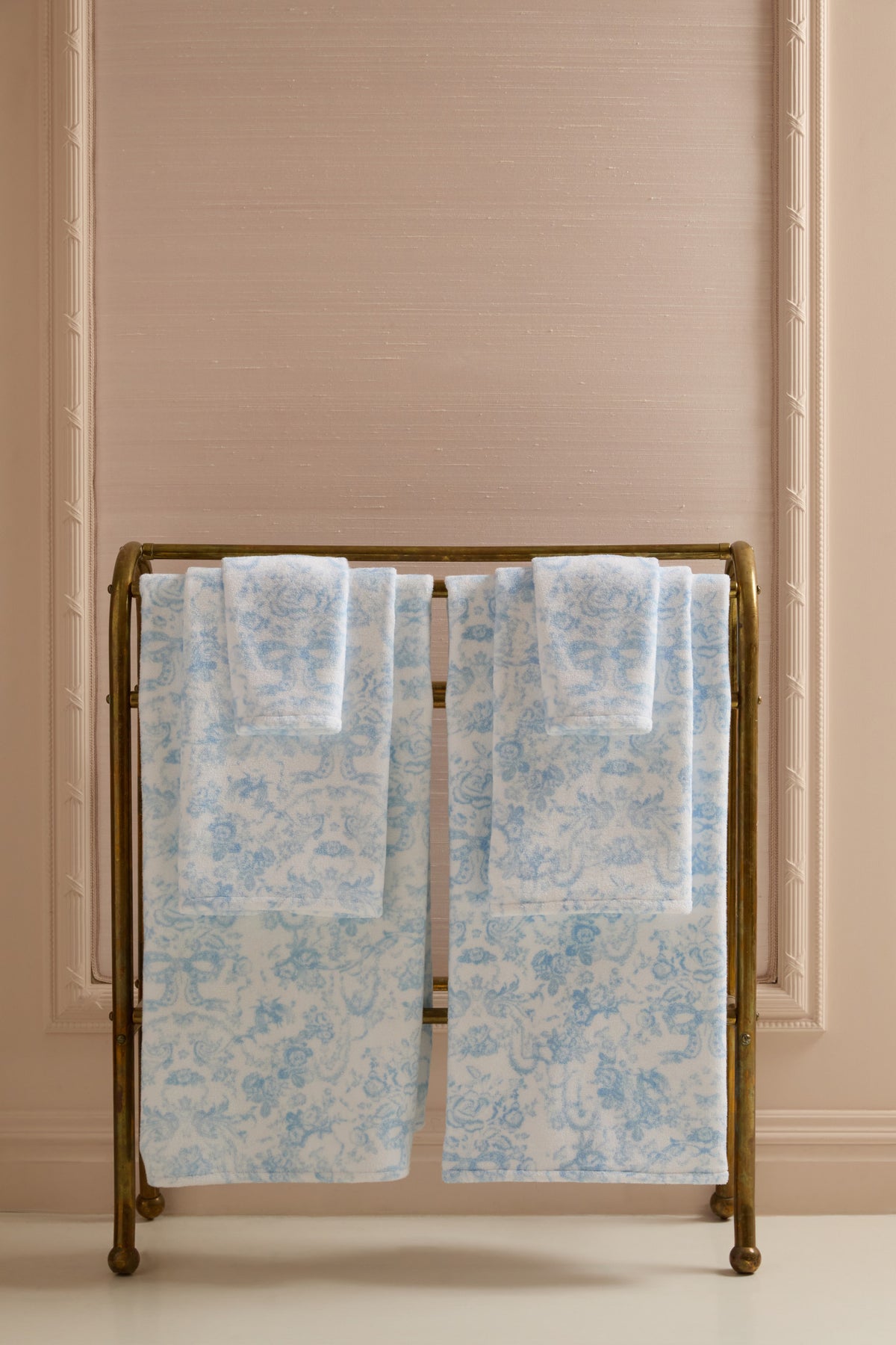 Pair of light blue cotton hand towels with all-over floral print, folded