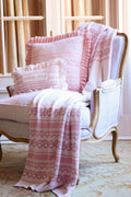 Pink fair isle jacquard knit throw pillow with patterned bands and ruffled edges