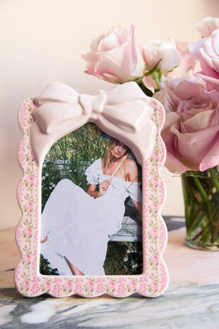 Pink floral decorative photo frame with large satin bow and scalloped border