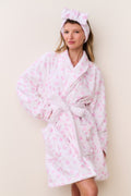 Pink floral cotton bathrobe with shawl collar and tie belt, full front view on model