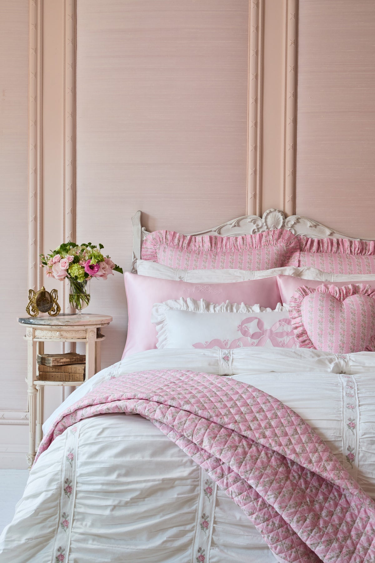 Pink diamond-quilted quilt with ruffled trim and light floral print