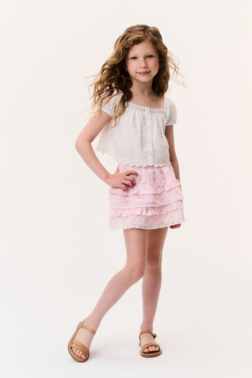 Girls light pink tiered ruffle mini skirt, front view