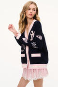 Wool varsity cardigan in navy with pink trim and button-front, long sleeves