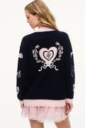 Navy wool varsity cardigan back view with heart wreath embroidery and pink hem trim