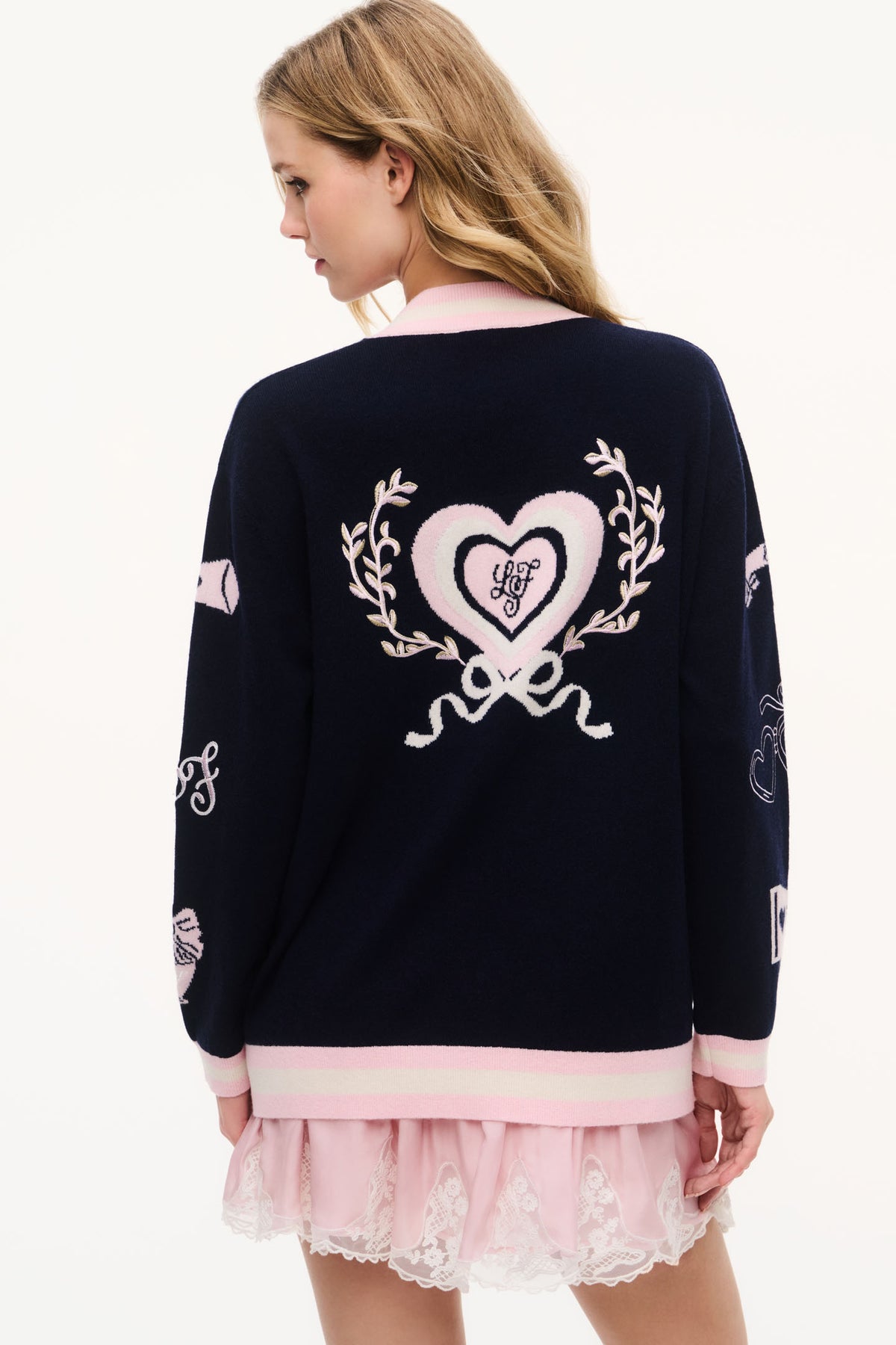 Navy wool varsity cardigan back view with heart wreath embroidery and pink hem trim