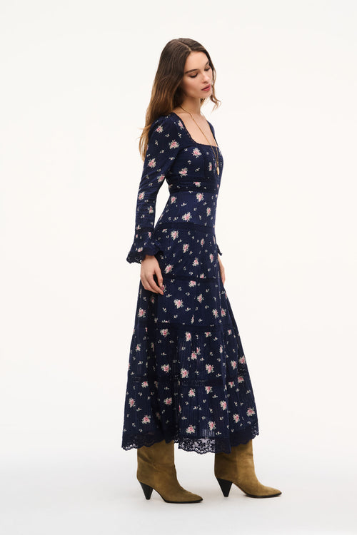 Navy floral maxi dress side view with long sleeves and tiered skirt