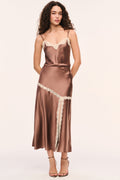 Mocha satin slip skirt with cream lace trim around the hips and vertical trim on edge of the front slit, front view
