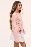 Tween pink textured knit pullover side view with ribbon threaded through and bow at hem
