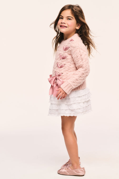 Girls' pink cable-knit cardigan side with large ribbon threaded through and bow at hem, textured knit and long sleeves