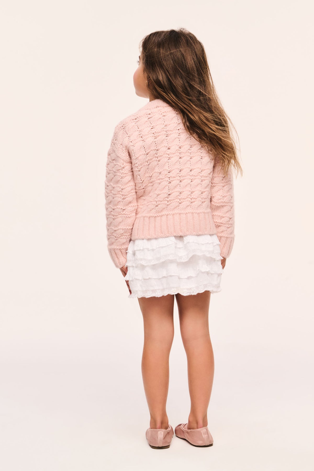 Girls' pink cable-knit cardigan, back view with ribbed hem and cuffs