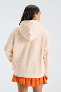 Cream patterned Nacova hoodie back view with drawstring hood.