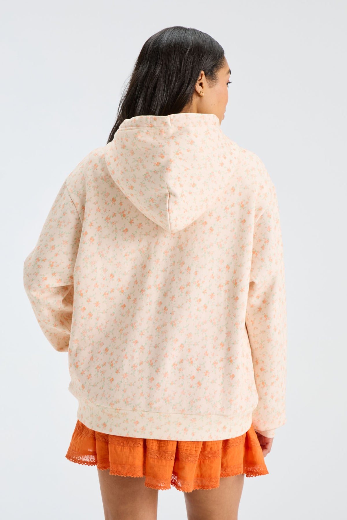 Cream patterned Nacova hoodie back view with drawstring hood.