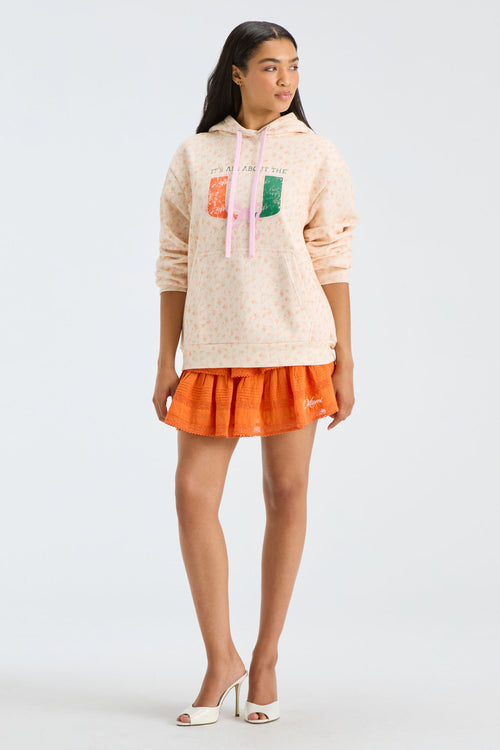 Light peach graphic hoodie with pullover hood and drawstring, long sleeves