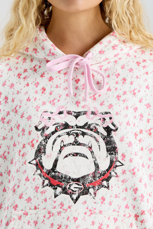 Pink floral-print hoodie with hood tie ribbon and bold Texas longhorn logo graphic
